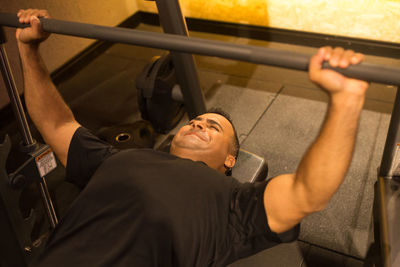 High angle view of smiling young woman looking up