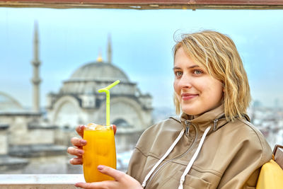 Portrait of smiling young woman outdoors