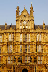 Low angle view of clock tower against sky