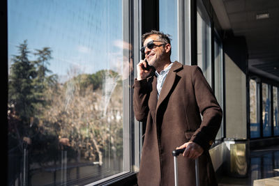 Full length of young man using mobile phone