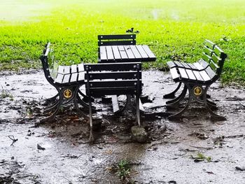 Empty bench in park during rainy season