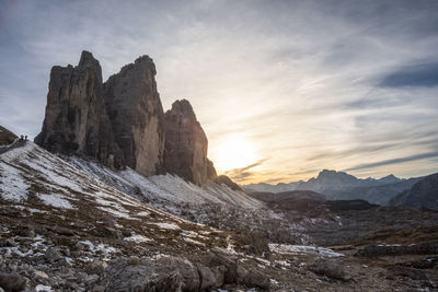 Rock formations against sky during sunset