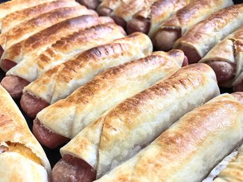 High angle view of sausage rolls on baking sheet