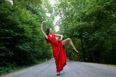 Rear view of woman standing on road