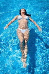 High angle view of woman swimming in pool