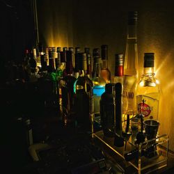 Panoramic shot of bottles on bar counter