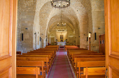 Empty pews in church seen through entrance