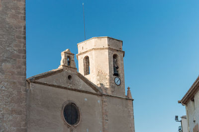 Low angle view of historic building against clear blue sky