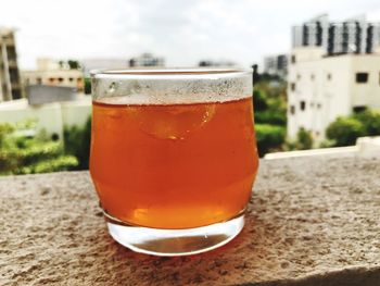 Close-up of beer in glass against sky