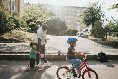 Father and daughters spending time actively outdoors