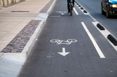 Separate bicycle lane on the street, white painted bike on asphalt, urban traffic and transportation