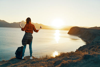 Full length of man standing on beach during sunset