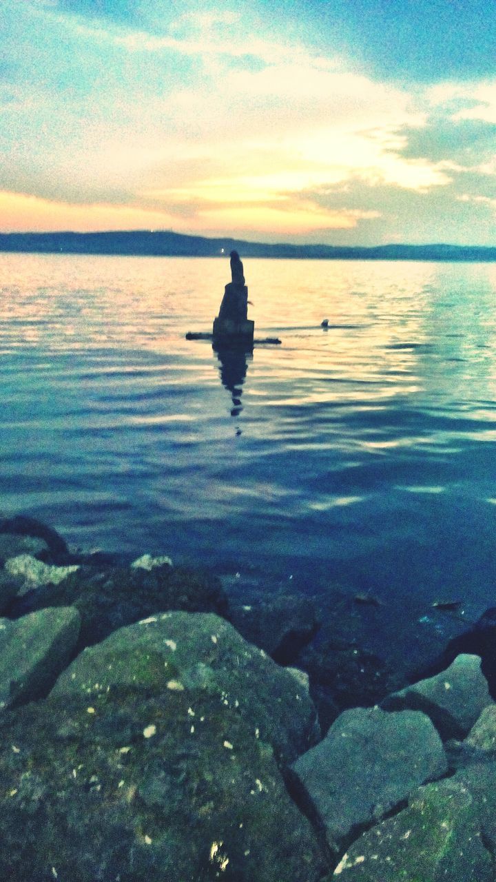 water, tranquility, sky, tranquil scene, scenics, beauty in nature, reflection, nature, rock - object, cloud - sky, sunset, sea, idyllic, lake, rippled, cloud, silhouette, horizon over water, outdoors, non-urban scene