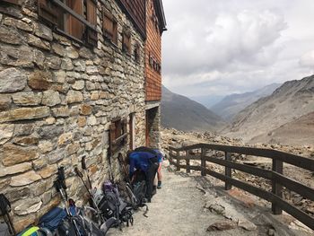 Rear view of woman on mountain against sky