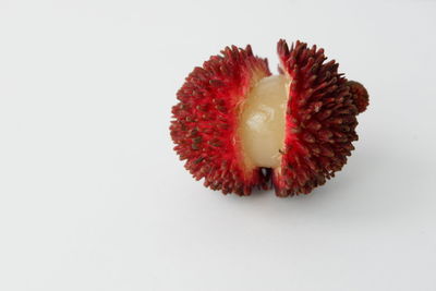 Close-up of strawberry over white background