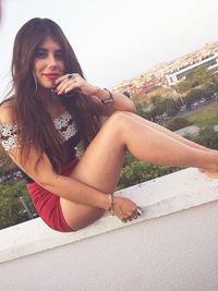 Portrait of young woman sitting outdoors