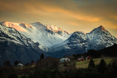 Scenic view of snowcapped mountains against sky during sunset