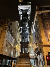 Low angle view of illuminated buildings in city at night