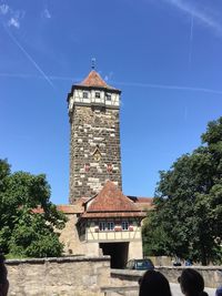 Low angle view of bell tower against blue sky