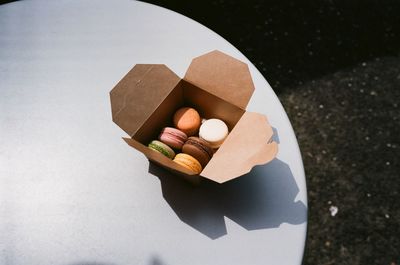 High angle view of macaroons in box on table