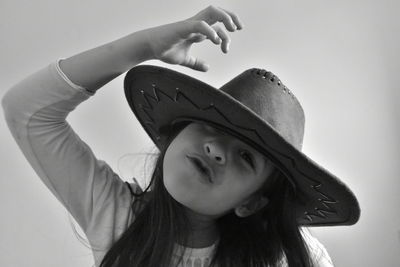 Close-up portrait of girl holding hat