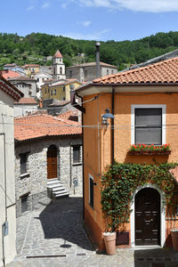 A narrow street between the old houses of sasso di castalda, a village of basilicata region, italy.