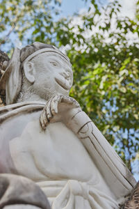 Low angle view of statue against trees