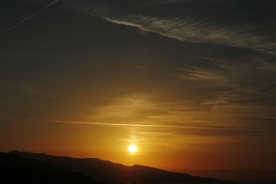 Low angle view of silhouette mountains against sky during sunset