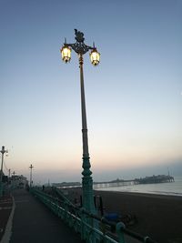 Street light on beach against clear sky