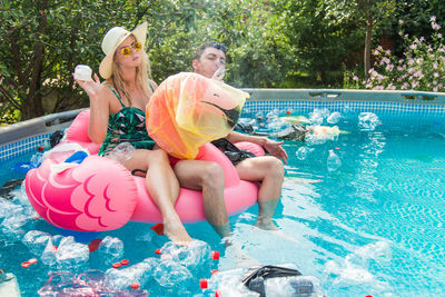 People sitting in swimming pool