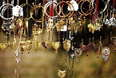Close-up of illuminated decorations hanging in store for sale