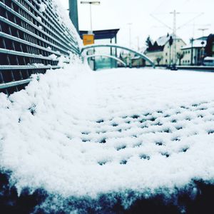 Close-up of snow covered built structure against sky