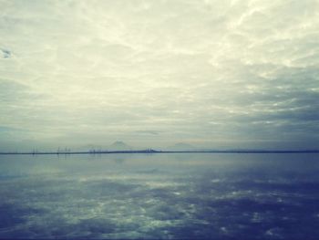 Scenic view of sea against cloudy sky