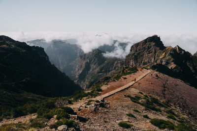 Hiking trail on red rock soil on pico do arieiro