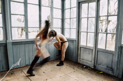 Shirtless women in abandoned room