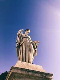 Low angle view of statue against sky