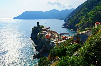 High angle view of sea and houses against sky