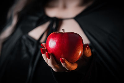 Close-up of hand holding apple