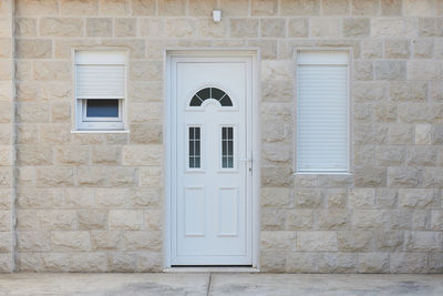 White front door and stone wall in a residential building