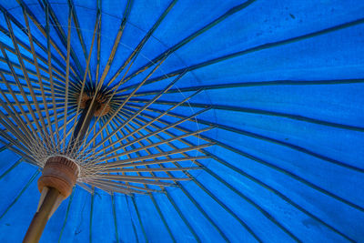 Low angle view of ferris wheel against blue sky