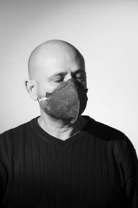Portrait of a man wearing protective mask against a black background. salvador, bahia, brazil