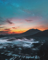 Scenic view of mountains against sky at night