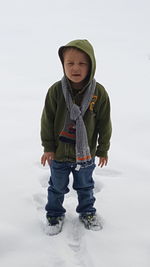 Cute boy standing on snow