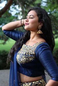 Beautifull indian girl in blue saree with heads up postion closed eyeys