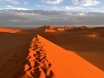 Scenic view of desert against sky during sunset