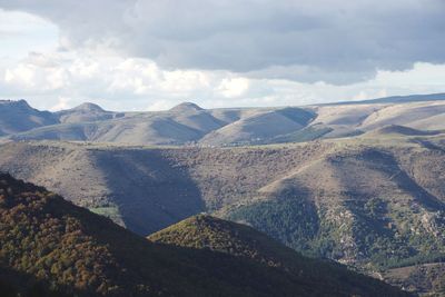 Scenic view of mountains against cloudy sky