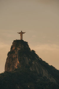 Low angle view of cross on rock