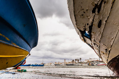 Boats moored on beach against sky