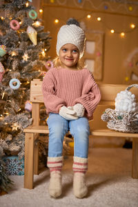 Full length of boy standing on sofa at home