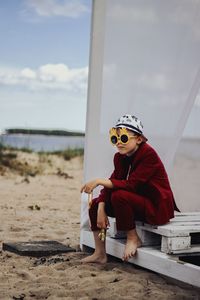 Portrait of young man sitting at beach